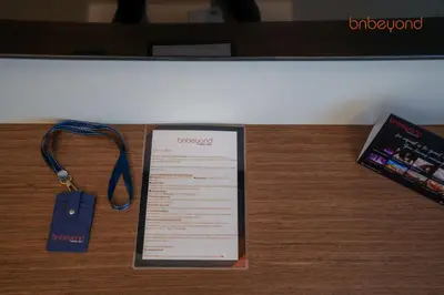 a clipboard and a keychain on a table with a book at Private Beach and Pool Vibes at Palace Residences in Dubai