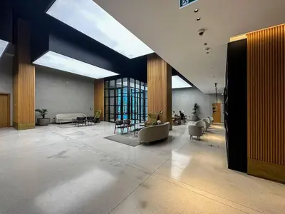 a large lobby with chairs and tables in a building at Marquise Square 410 in Dubai
