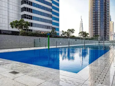 a swimming pool in a city with tall buildings at Marquise Square 410 in Dubai