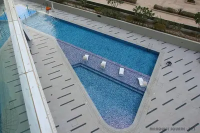 an overhead view of a swimming pool in a building at Marquise Square 410 in Dubai