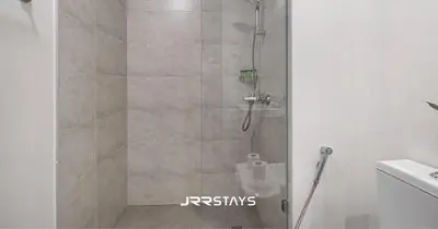 a shower with a glass door in a bathroom at Stylish Luxury 1BR - Modern Design - JVC in Dubai