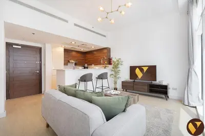 a living room with a couch and a table at Vogue Business Bay - Bay Square close to Downtown Dubai Mall and Burj Khalifa, One Bedroom Apartment with Balcony and City view in Dubai