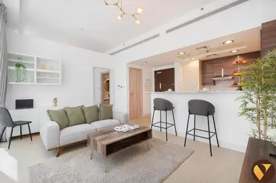 a living room with a couch and a table at Vogue Business Bay - Bay Square close to Downtown Dubai Mall and Burj Khalifa, One Bedroom Apartment with Balcony and City view in Dubai