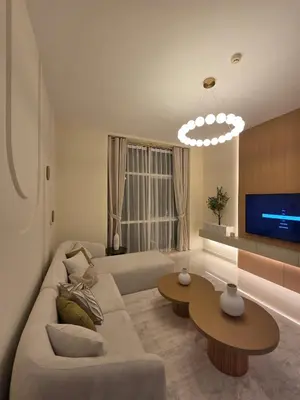 a living room with a couch and a tv at Duja Tower 4404 in Dubai