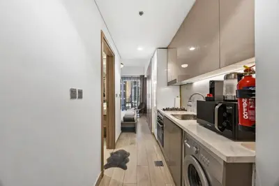 a kitchen with a dog sitting on the floor in the hallway at Elite Escape - Stylish Getaway in Azizi Riviera 43 in Dubai