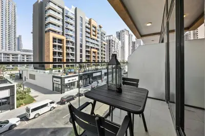 a balcony with a table and chairs and a view of a city at Elite Escape - Stylish Getaway in Azizi Riviera 43 in Dubai