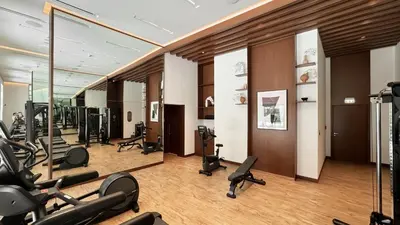 a gym with treadmills and exercise equipment in a building at 833keys - 1BR - Lagoon Access - Vida Creek Beach - Creek Harbour - Dubai in Dubai