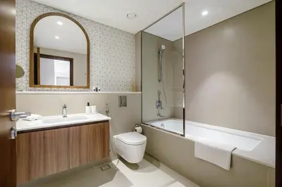 a bathroom with a tub and a toilet and a sink at 833keys - 1BR - Lagoon Access - Vida Creek Beach - Creek Harbour - Dubai in Dubai
