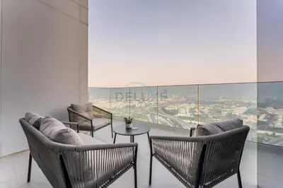 a room with chairs and a table with a view at Duplex Apartment Next to Zabeel Park, Steps from the Metro Station, and Minutes to Downtown Dubai, Al Kifaf 1 Residences East, Bur Dubai, by Deluxe Holiday Homes in Dubai