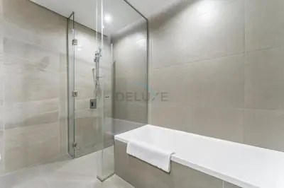 a bathroom with a shower and a white sink at Duplex Apartment Next to Zabeel Park, Steps from the Metro Station, and Minutes to Downtown Dubai, Al Kifaf 1 Residences East, Bur Dubai, by Deluxe Holiday Homes in Dubai