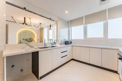 a kitchen with white cabinets and a sink at Duplex Apartment Next to Zabeel Park, Steps from the Metro Station, and Minutes to Downtown Dubai, Al Kifaf 1 Residences East, Bur Dubai, by Deluxe Holiday Homes in Dubai