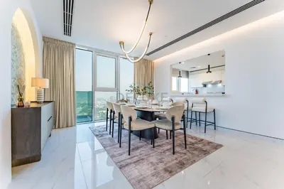 a dining room and kitchen with a table and chairs at Duplex Apartment Next to Zabeel Park, Steps from the Metro Station, and Minutes to Downtown Dubai, Al Kifaf 1 Residences East, Bur Dubai, by Deluxe Holiday Homes in Dubai
