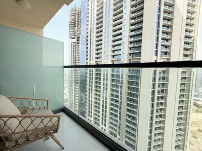 a room with a couch and a large window at Exquisite 2BR With Balcony in Business bay in Dubai