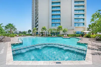 a swimming pool in front of a tall building at Exquisite 2BR With Balcony in Business bay in Dubai