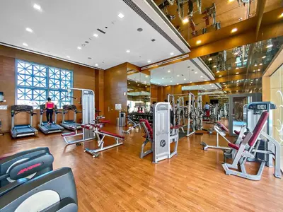a gym with several treadmills and machines in it at Silkhaus Chic Studio in Downtown at Claren Tower in Dubai