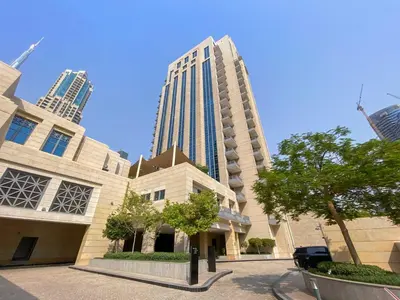 a large building with tall buildings in the background at Silkhaus Chic Studio in Downtown at Claren Tower in Dubai