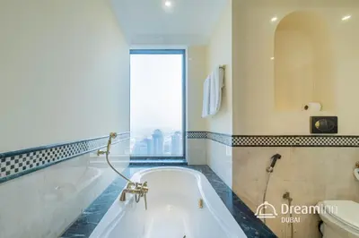a bath tub in a bathroom with a large window at Dream Inn - Timeless Arabic-Inspired Penthouse with Private Pool and Sweeping Ain Dubai Views in Dubai