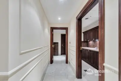 a hallway of a kitchen with a mirror at Dream Inn - Timeless Arabic-Inspired Penthouse with Private Pool and Sweeping Ain Dubai Views in Dubai