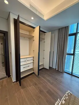 a room with white closets and a large window at Luxury 2BR - Nobles Tower - Business Bay in Dubai
