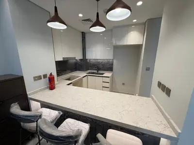 a kitchen with a counter with stools in it at Luxury 2BR - Nobles Tower - Business Bay in Dubai