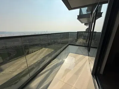 an empty glass balcony with a view of the beach at Luxury 2BR - Nobles Tower - Business Bay in Dubai