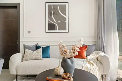 a living room with a couch and a table at Silkhaus Modern 2BR in Merano Tower in Business Bay in Dubai