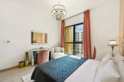 a bedroom with a bed and a large window at Luxury 1BD Stay in Lamtara 2, Near Jumeirah Burj in Dubai