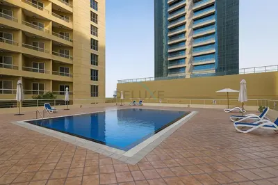 a swimming pool on the roof of a building at Balcony Offering Captivating Lake Views 1BR, Just a Hop from the Golf Course, Lakeside B, Dubai Production City by Deluxe Holiday Homes in Dubai