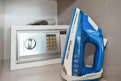 a pair of scissors sitting on top of a microwave at CH Burj Khalifa View Pool 1BR Paramount Escape in Dubai