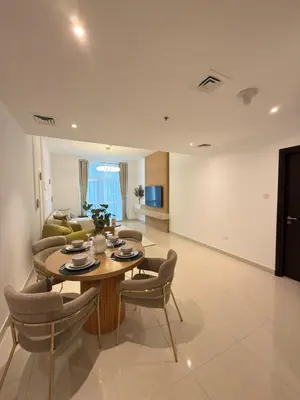 a living room with a table and chairs and a couch at Duja Tower 4405 in Dubai