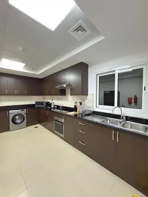 a large kitchen with brown cabinets and a sink at Duja Tower 4405 in Dubai