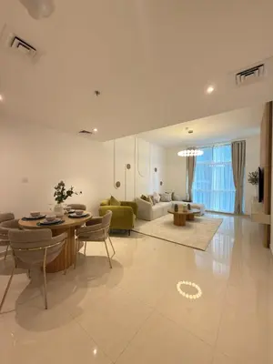 a living room with a table and a couch at Duja Tower 4405 in Dubai