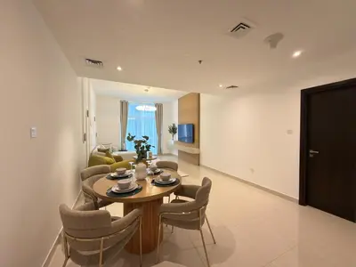 a living room with a table and chairs and a couch at Duja Tower 4405 in Dubai