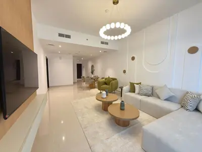 a living room with a couch and tables and chairs at Duja Tower 4405 in Dubai
