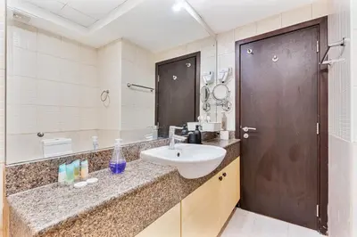 a bathroom with a sink and a large mirror at Chic 4-Sleeper near JBR Beach & Dubai Marina Mall in Dubai