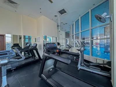 a gym with two treadmills in a building at Chic 4-Sleeper near JBR Beach & Dubai Marina Mall in Dubai
