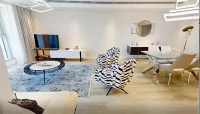 a living room with a table and chairs at SkyRise Apartment with Stunning Sea View on 89 Floor in Dubai