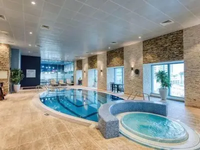 a large swimming pool in a large room at SkyRise Apartment with Stunning Sea View on 89 Floor in Dubai