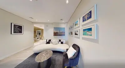 a bedroom with a bed and a table and chairs at SkyRise Apartment with Stunning Sea View on 89 Floor in Dubai