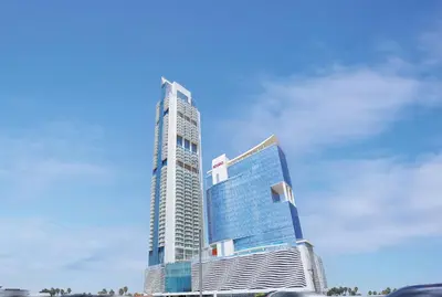 a tall building in front of a blue sky at Luxery Hotel Apartment l Novotel Residence l JVT in Dubai