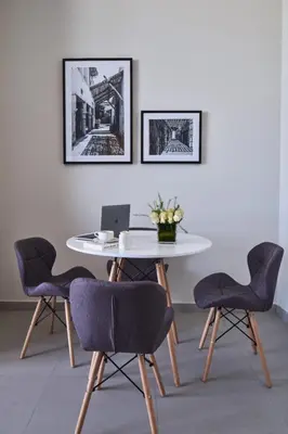 a white table with chairs and a laptop on it at Luxery Hotel Apartment l Novotel Residence l JVT in Dubai