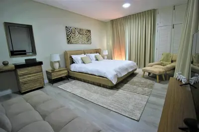 a bedroom with a bed and a television in it at Premium 1BR on High Floor with Stunning Sea View and Balcony in Dubai