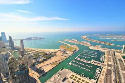an aerial view of a city and the ocean at Premium 1BR on High Floor with Stunning Sea View and Balcony in Dubai
