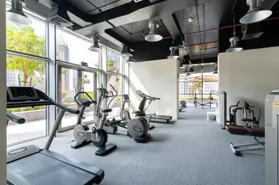 a gym with several exercise bikes in a room with windows at FIRST CLASS 2BR Elegant Duplex Haven in Dubai