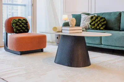 a living room with a couch and a table and a chair at Waterfront Serenity in Dubai Marina in Dubai