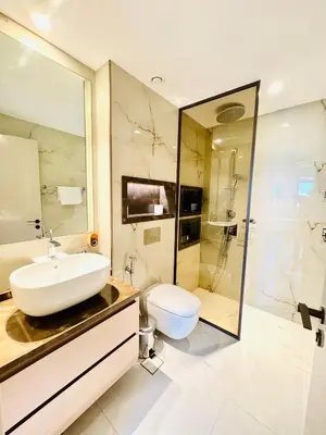 a bathroom with a sink and a toilet and a shower at Burj Khalifa View 2 Bed Luxury Apartment in Dubai