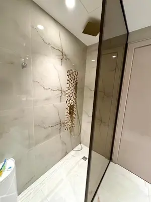 a bathroom with a shower and a toilet at Burj Khalifa View 2 Bed Luxury Apartment in Dubai