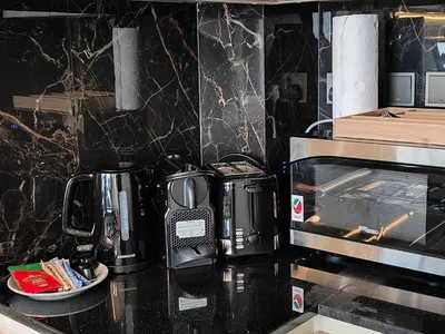 a kitchen counter with a coffee maker and a microwave at Cozy Modern 1BR with Dubai Skyline View in Dubai