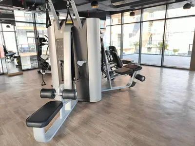 a gym with treadmills and machines in a room at Cozy Modern 1BR with Dubai Skyline View in Dubai