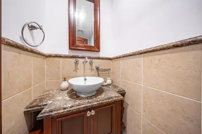 a bathroom with a sink and a mirror at Full Burj View - Souk vibe one-bedroom apartment in Dubai